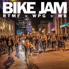 An image of people riding bicycles through Winnipeg at night with the words "Bike Jam RTMF x WPG x MB"