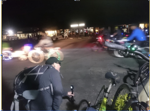 An image of the SJBP taken by GoPro, featuring people on bicycles riding by in a blur of lights