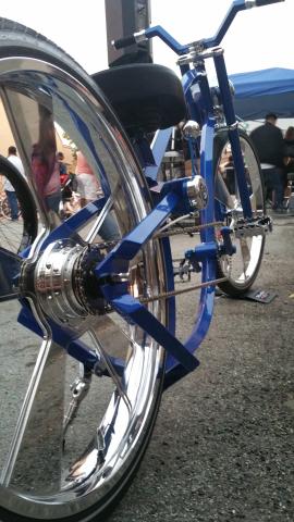 An image of a blue low rider bike with chrome wheels and handlebars.