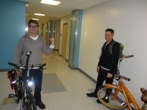 An image of researchers jay johnson and Matt Masucci with a black bicycle and an orange bicycle