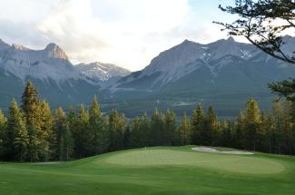 golf course with mountains in background